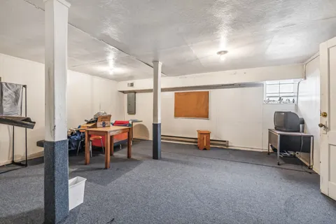 a view of a livingroom with furniture and a window