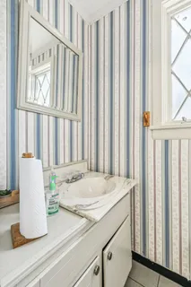 a room with a window and a white cabinet