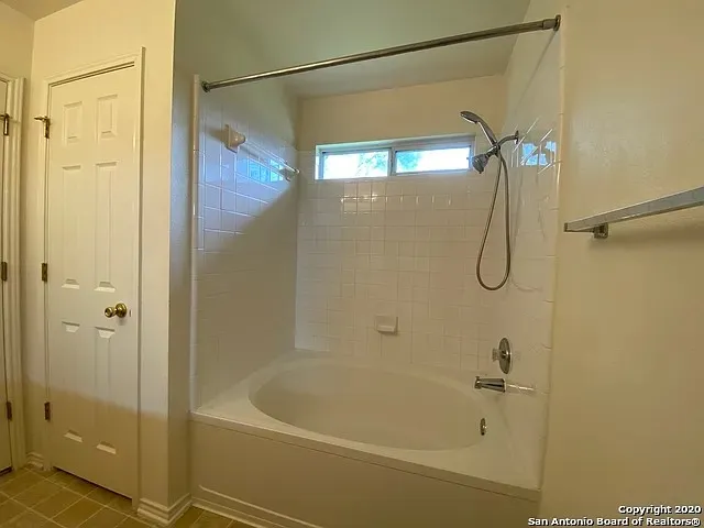 a bathroom with a glass shower door