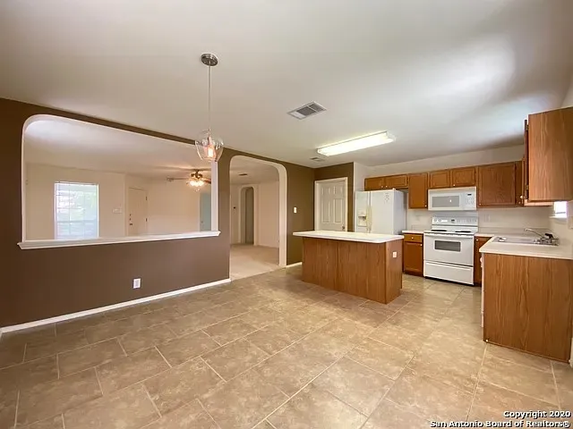 a view of kitchen with stainless steel appliances granite countertop a sink and a stove