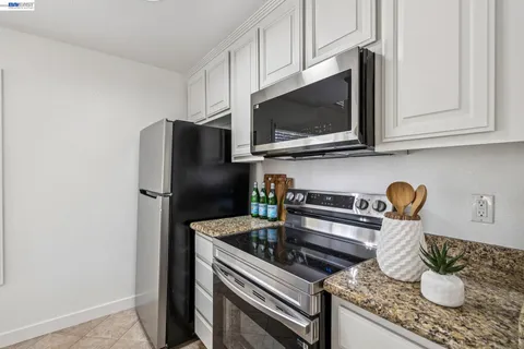 a kitchen with granite countertop cabinets and steel stainless steel appliances