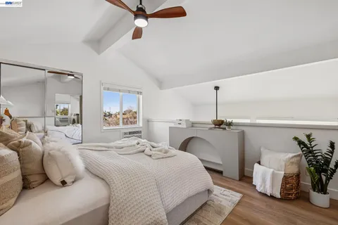 a bedroom with a large bed and a potted plant