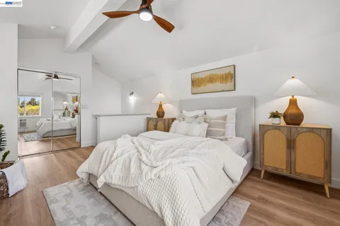 a bedroom with a bed and wooden floor