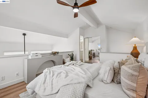 a bed room with a bed and a chair