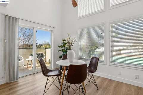 a dining room with furniture and wooden floor