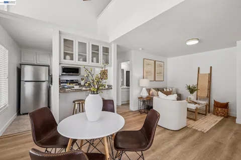 a dining room with furniture and wooden floor