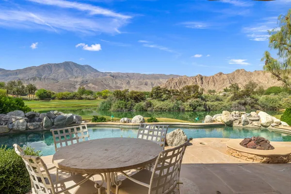 a view of a chairs and table in patio