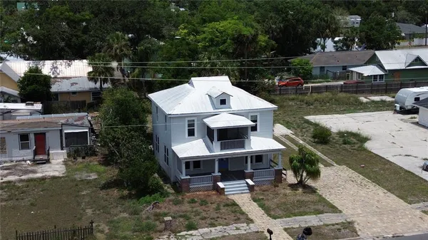 a view of a house with backyard space and sitting area
