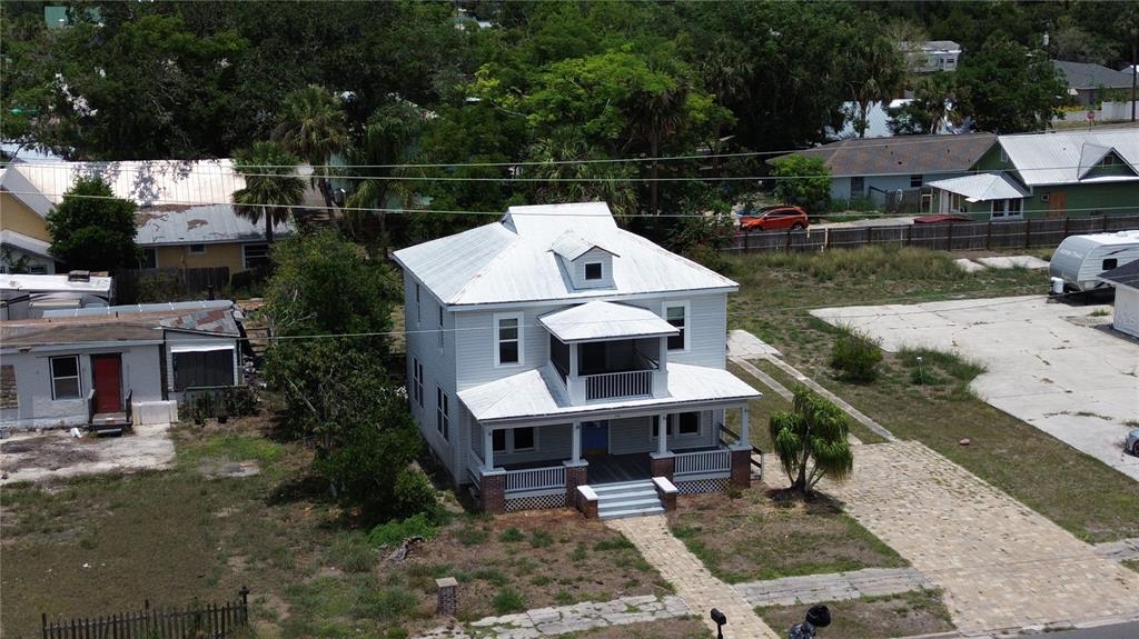 a view of a house with backyard space and sitting area