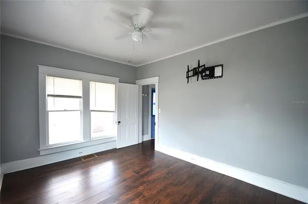 wooden floor in an empty room with a window
