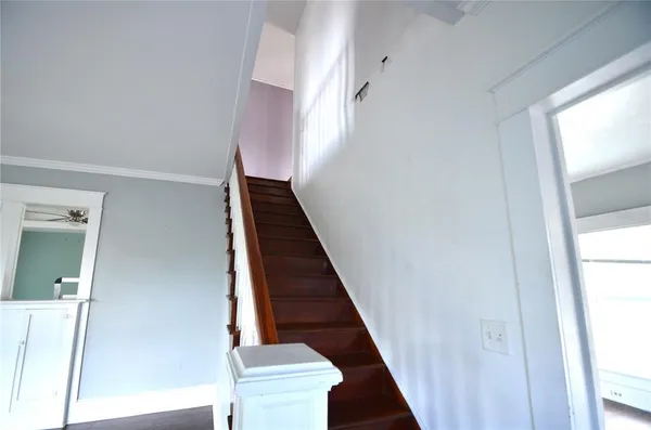 a view of entryway and hall with wooden floor