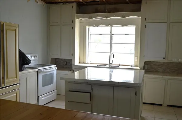 a kitchen with a window a sink and a stove