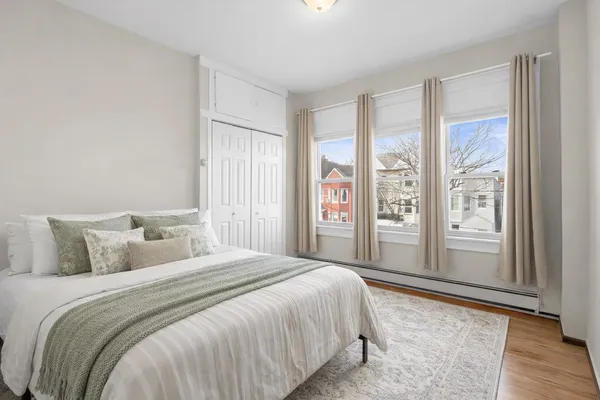 a bedroom with a large bed and a large window