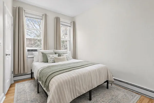 a bedroom with a bed and a window