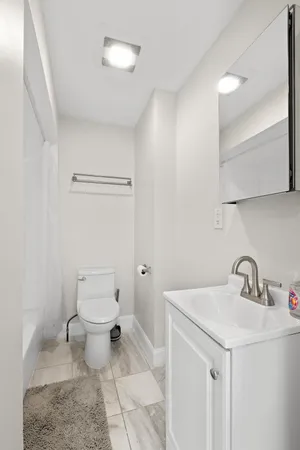 a bathroom with a sink a toilet and a mirror