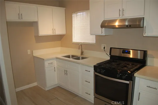 a kitchen with sink and cabinets
