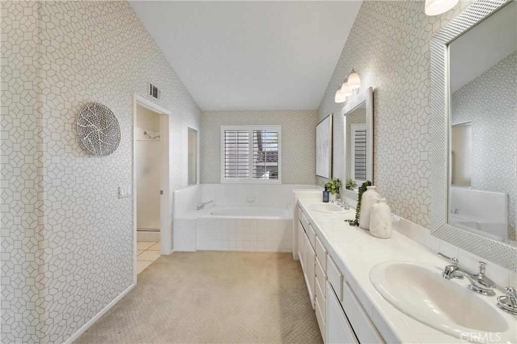 2325 Dunes Tustin, CA 92782 - Photo 17 of 25 a spacious bathroom with a bathtub sink and mirror