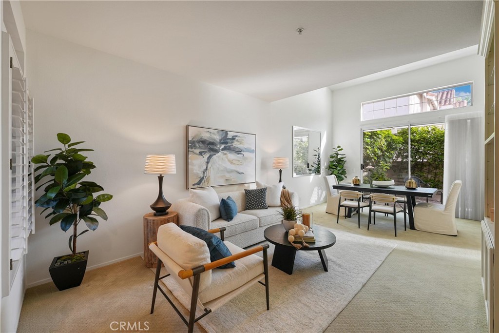 2325 Dunes Tustin, CA 92782 - Photo 2 of 25 a living room with furniture a potted plant and a large window
