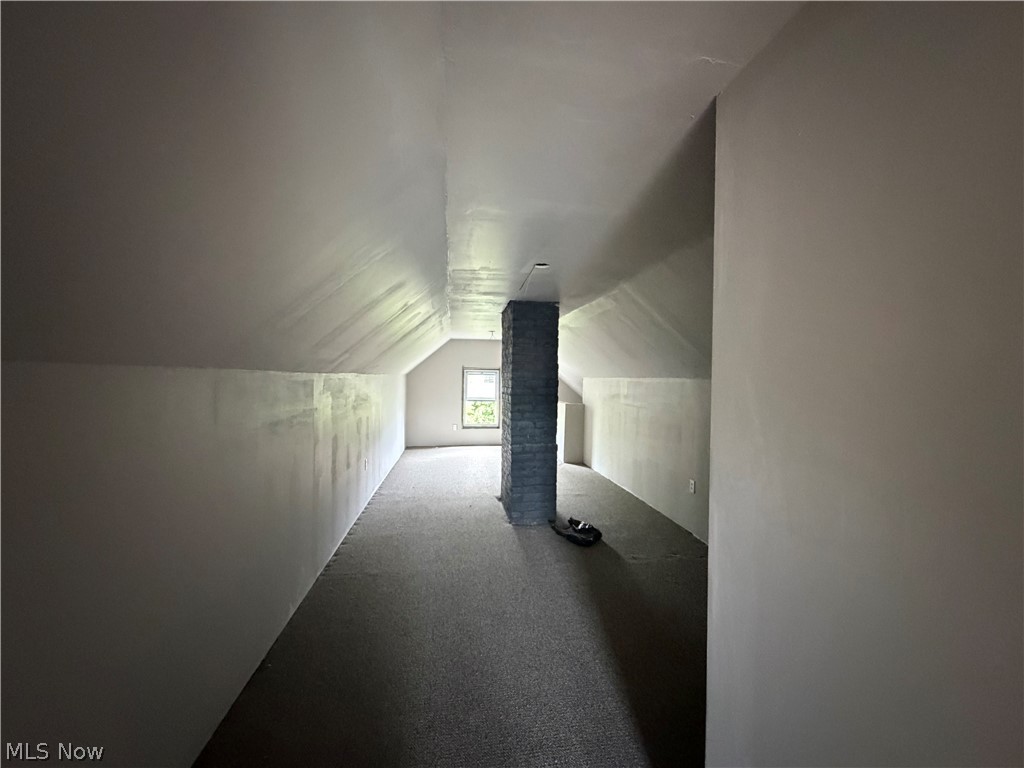 15317 Shiloh Road Cleveland, OH 44110 - Photo 26 of 29 Expansive attic space featuring sloped ceilings and a window offering natural illumination