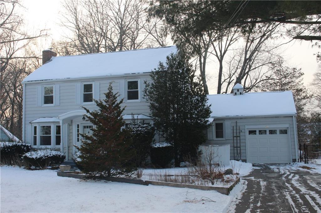 a front view of a house with a yard and a garage