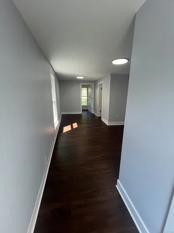 a view of an empty room and wooden floor