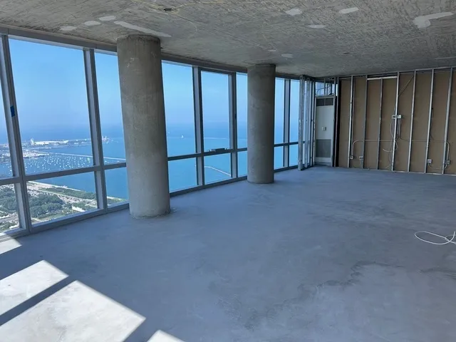 an empty room with sliding door and a balcony