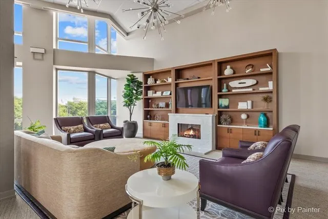 a living room with furniture a large window and a rug