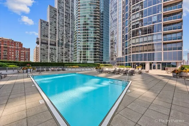 a swimming pool with outdoor seating and yard