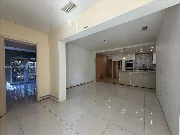 a view of a kitchen with a sink and cabinets