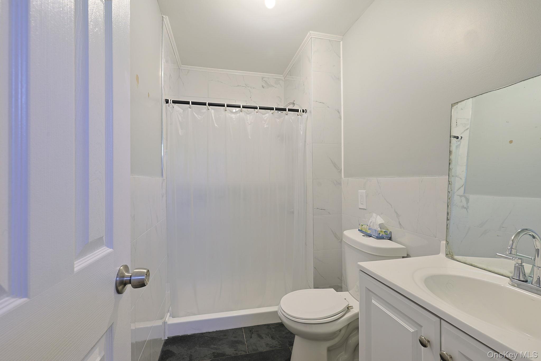 30 Rock Ridge Avenue Monticello, NY 12701 - Photo 11 of 19 a bathroom with a sink a toilet and shower