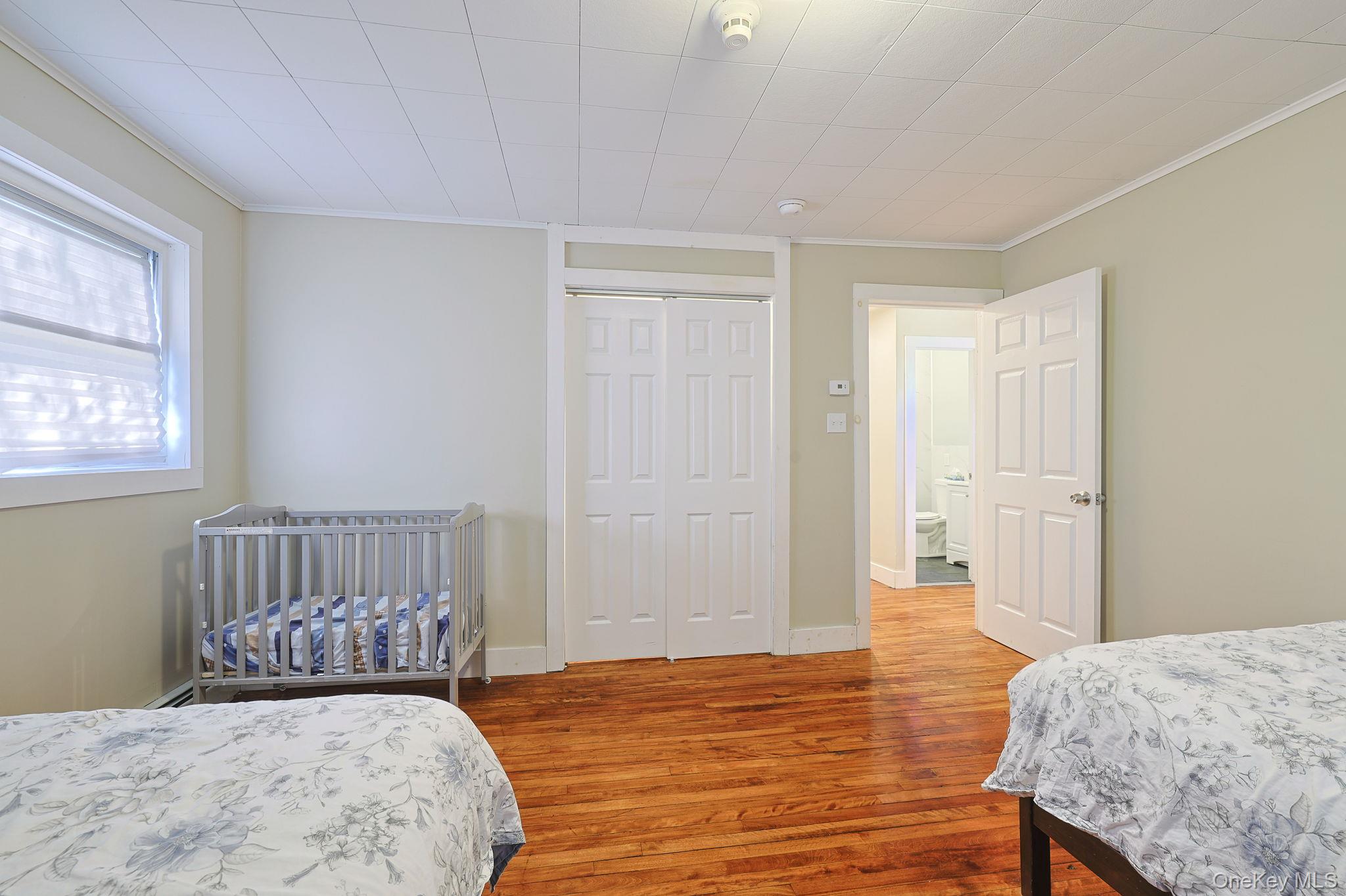 30 Rock Ridge Avenue Monticello, NY 12701 - Photo 13 of 19 a bedroom with a bed and wooden floor