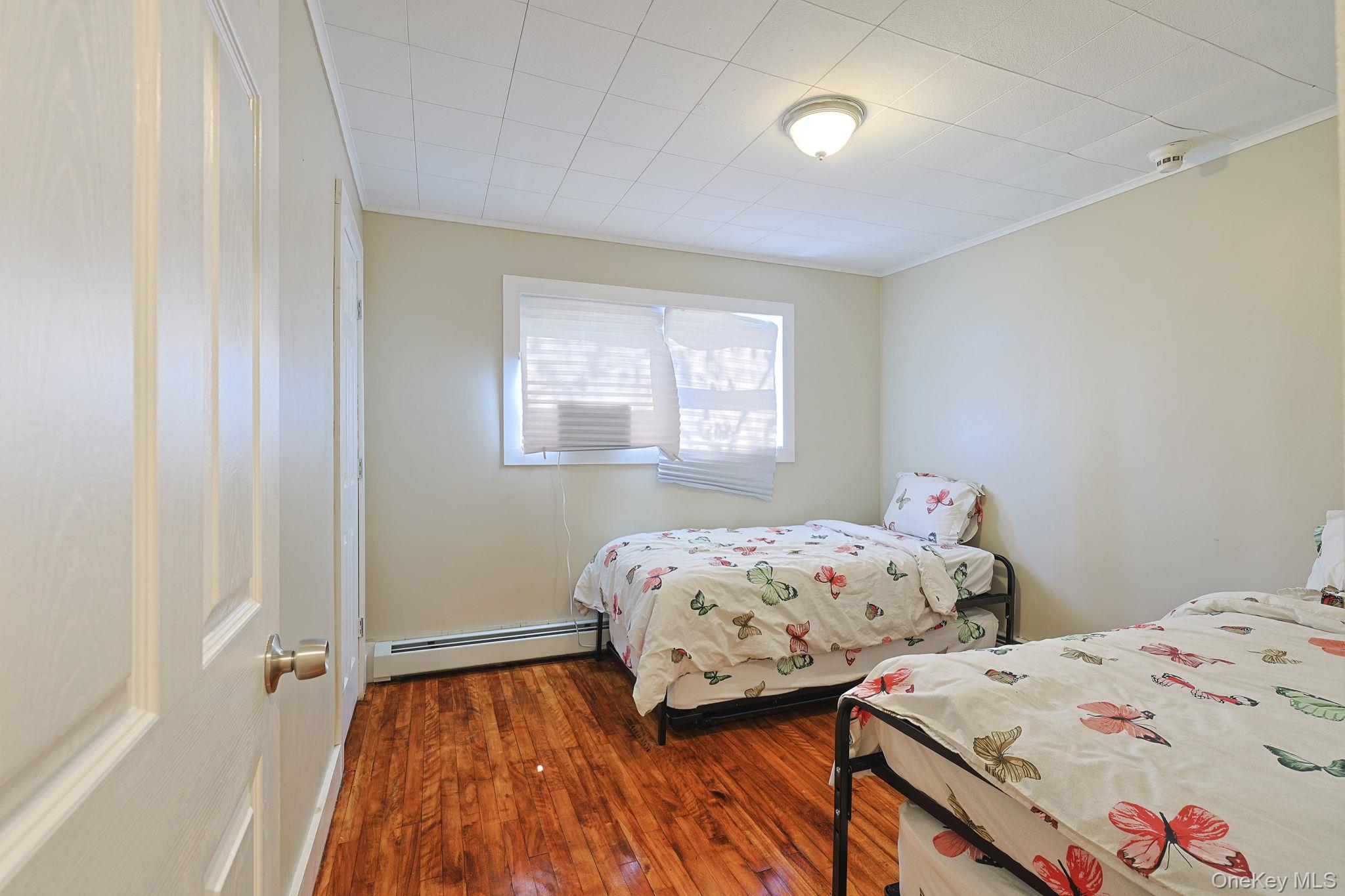30 Rock Ridge Avenue Monticello, NY 12701 - Photo 14 of 19 a bedroom with two beds and a window