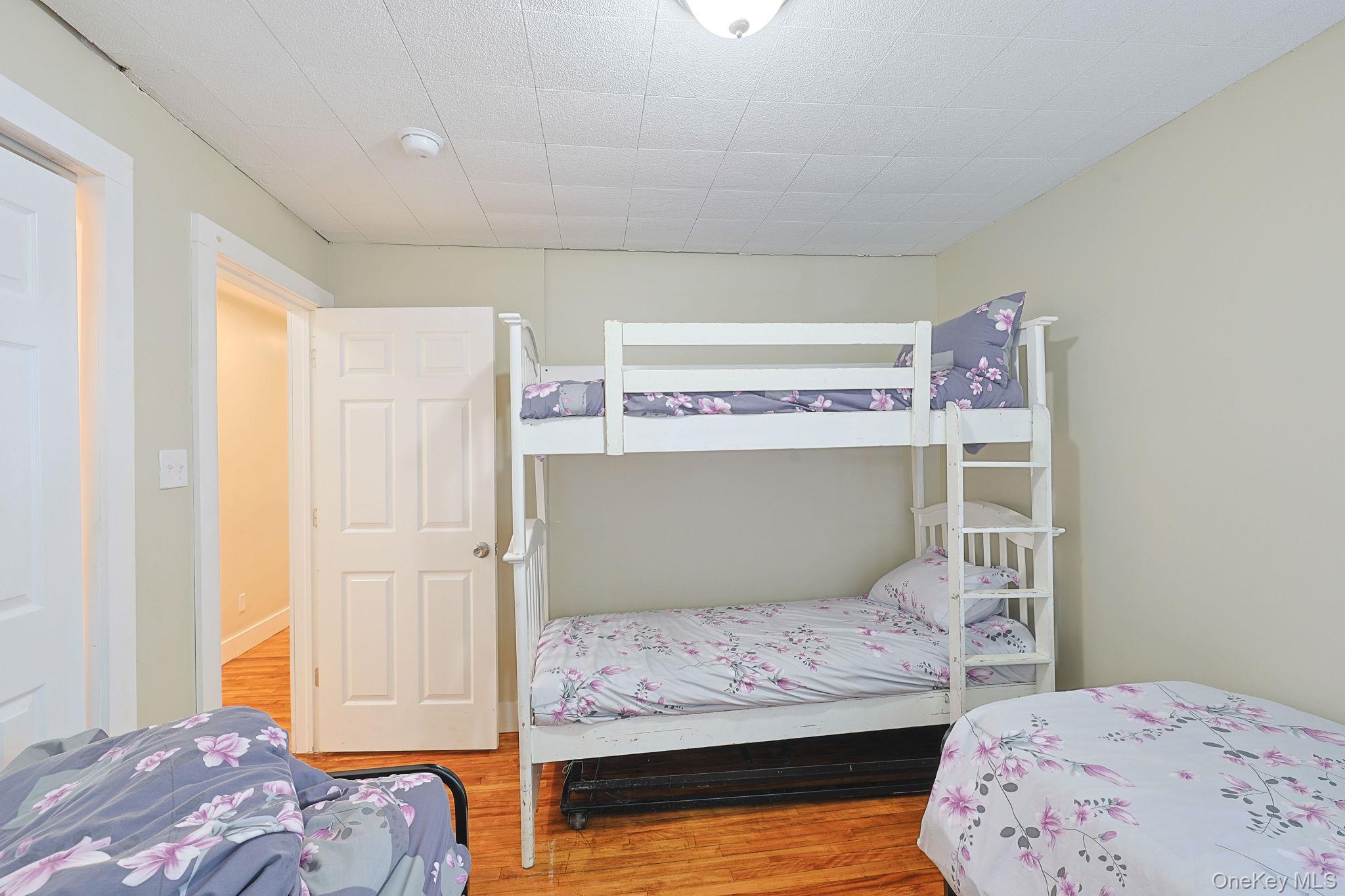 30 Rock Ridge Avenue Monticello, NY 12701 - Photo 17 of 19 a bedroom with a bed and two windows