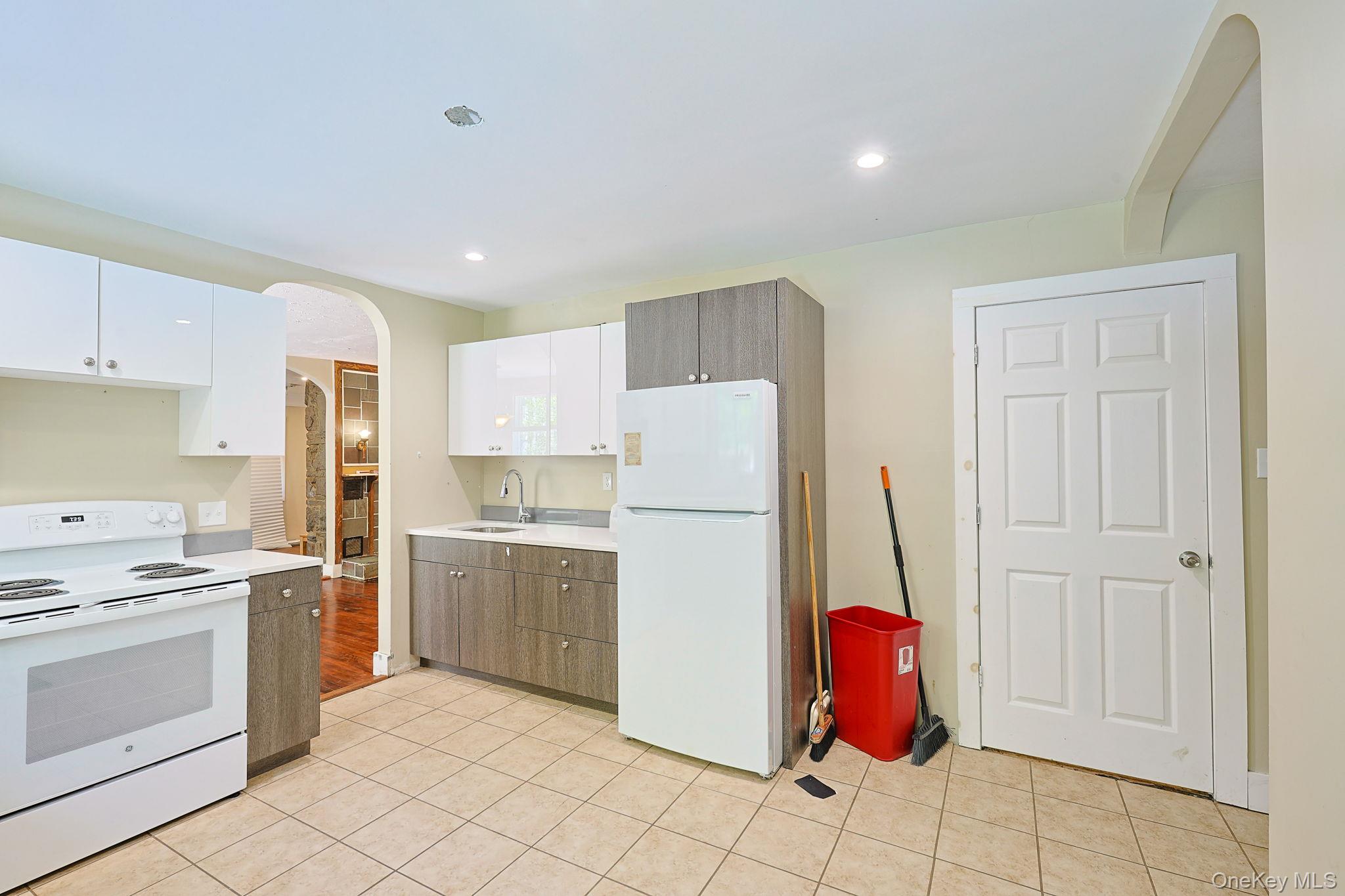 30 Rock Ridge Avenue Monticello, NY 12701 - Photo 2 of 19 a kitchen with a refrigerator sink and cabinets