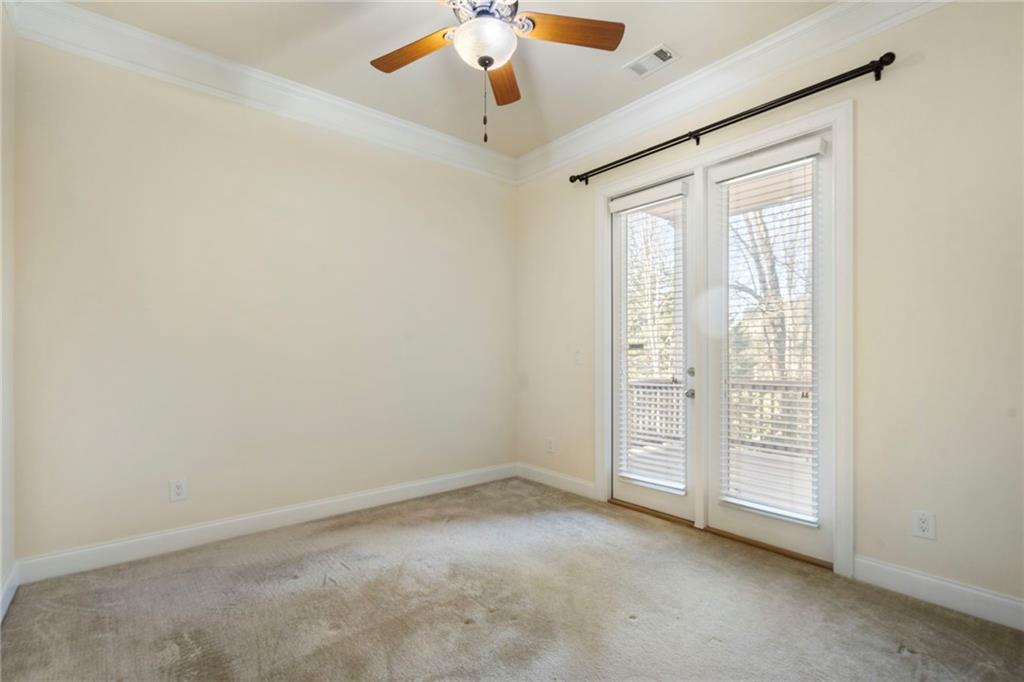 804 Morganton Drive Suwanee, GA 30024 - Photo 29 of 43 an empty room with chandelier fan and windows