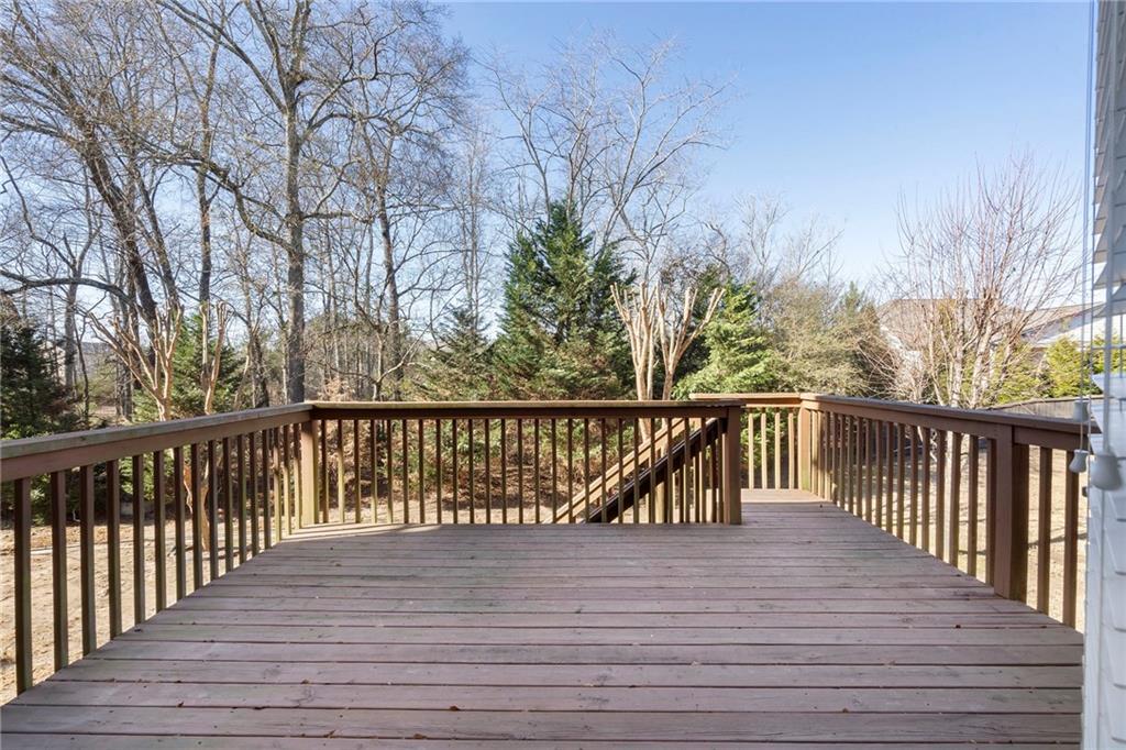 804 Morganton Drive Suwanee, GA 30024 - Photo 7 of 43 a balcony with wooden floor and trees