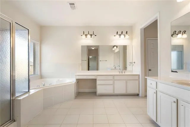 a bathroom with a tub sink and mirror