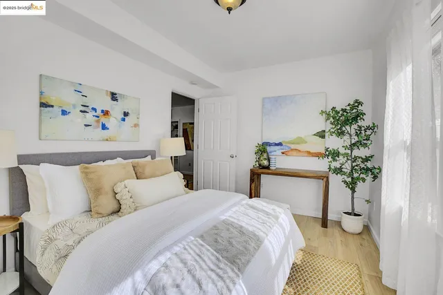 a bedroom with a bed and a painting on the wall