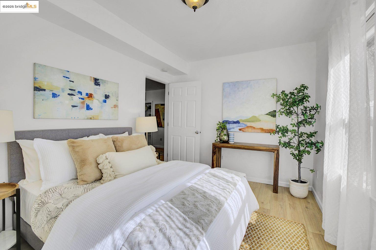 3830 Clarke Street Oakland, CA 94609 - Photo 15 of 41 a bedroom with a bed and a painting on the wall