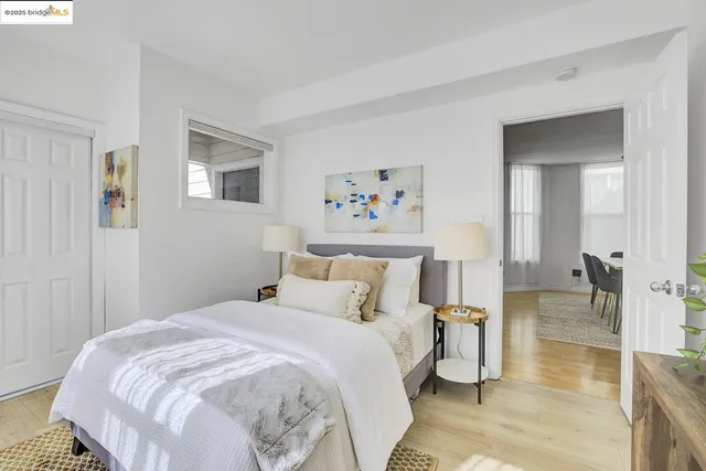 a bedroom with a bed and a painting on the wall