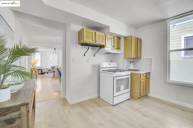 a kitchen with a white stove top oven and sink