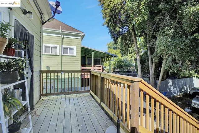 a view of balcony with wooden floor and fence