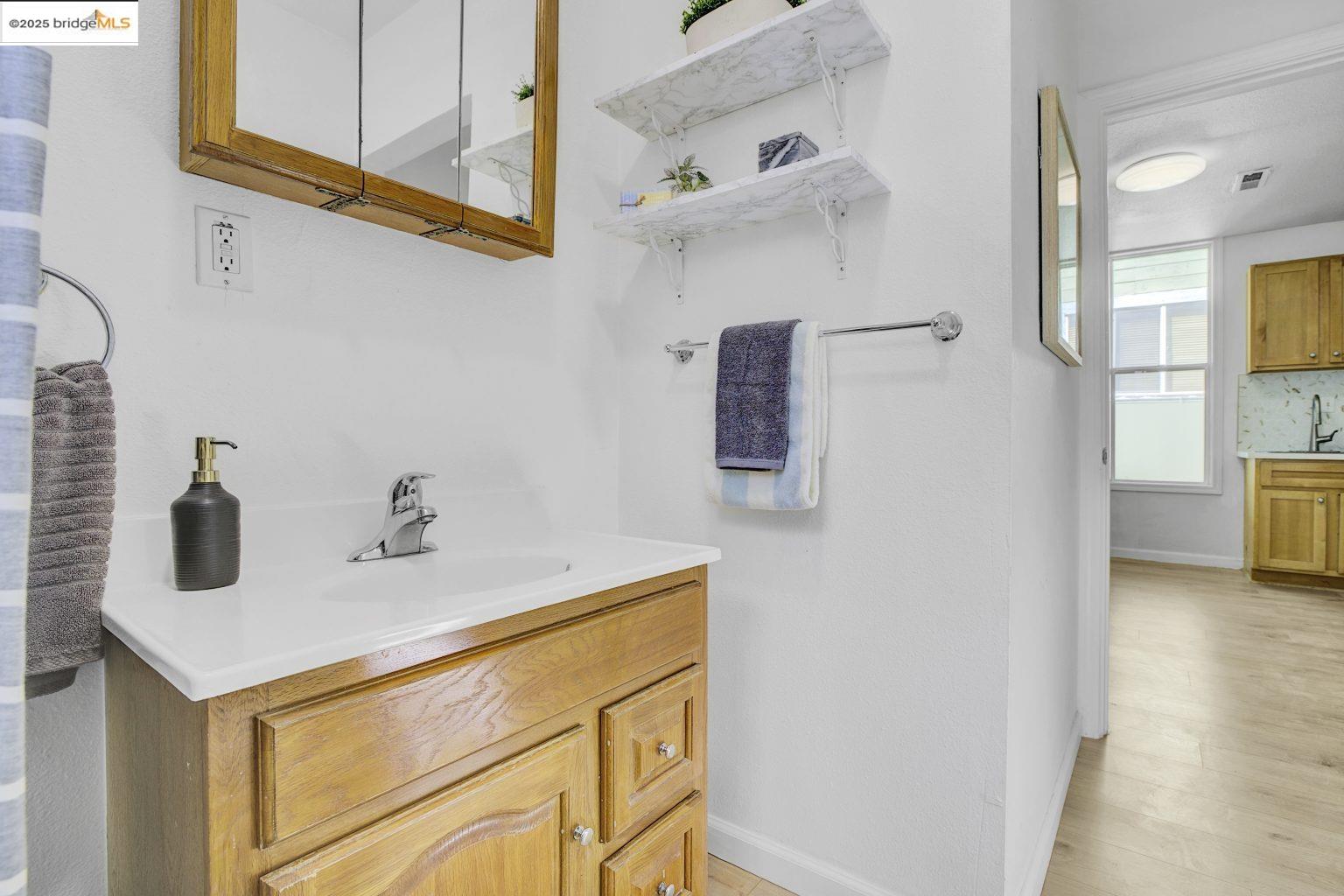 3830 Clarke Street Oakland, CA 94609 - Photo 29 of 41 a bathroom with a sink and a mirror