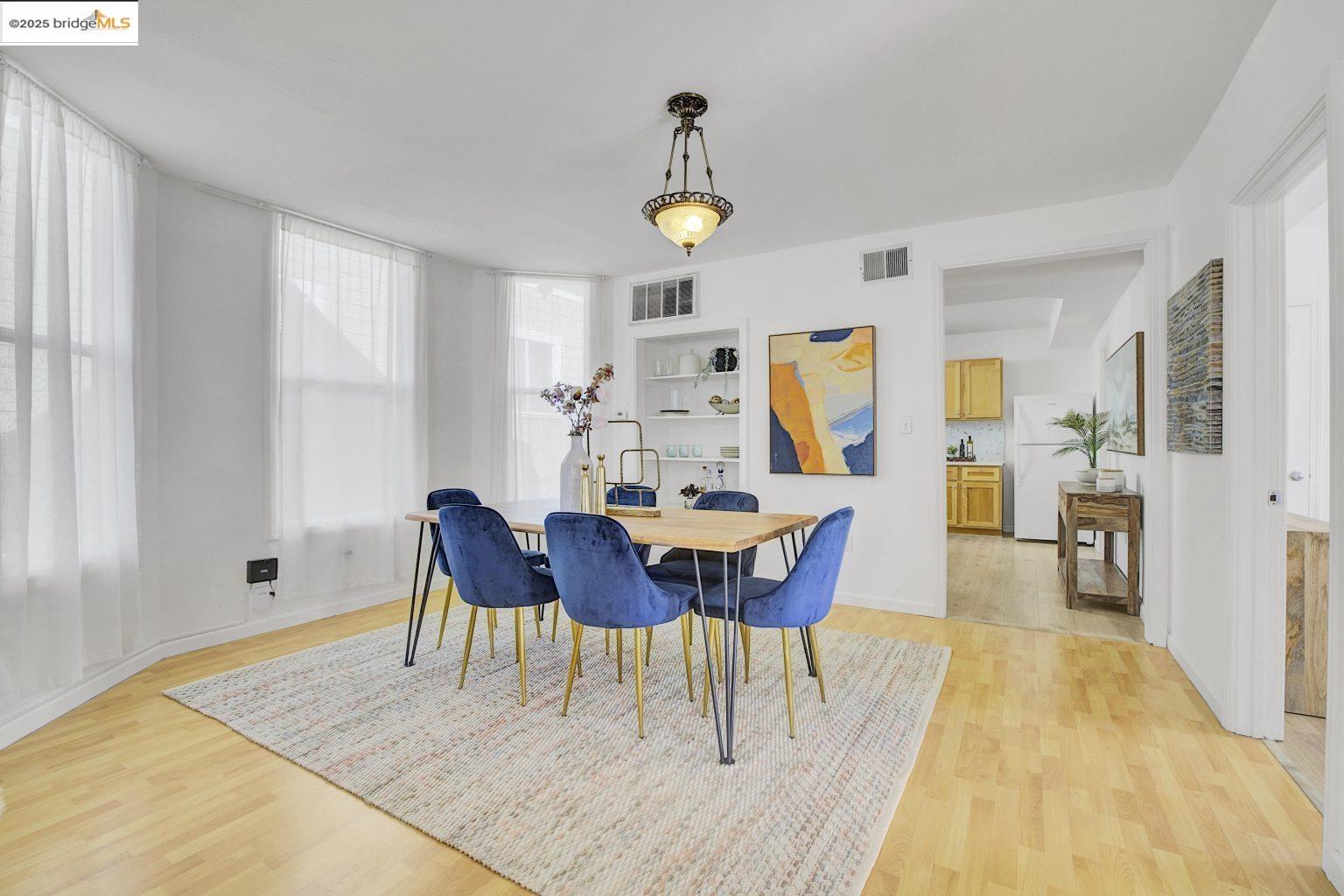 3830 Clarke Street Oakland, CA 94609 - Photo 10 of 41 a view of a dining room with furniture and wooden floor