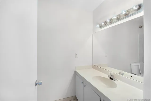 a view of a street sign under a large tree