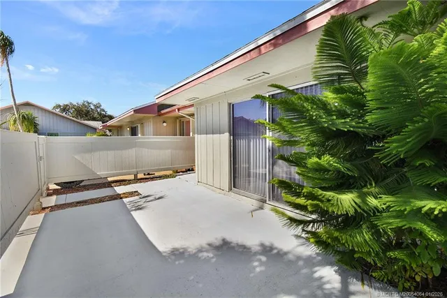 a backyard of a house with plants and trees