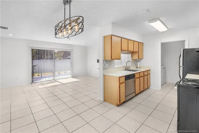 a kitchen with stainless steel appliances granite countertop a sink and a stove