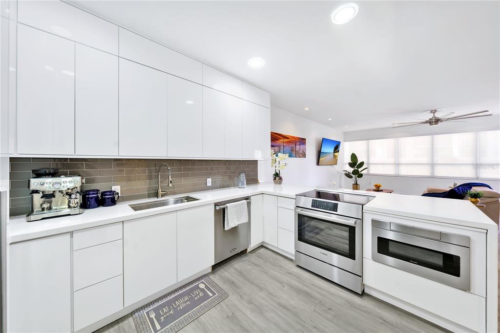 11 Island Avenue, Unit 309 Miami Beach, FL 33139 - Photo 16 of 28 a kitchen with white cabinets and white appliances