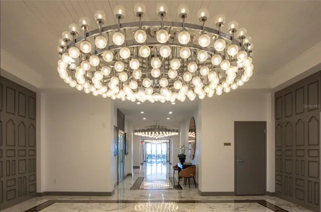 a lobby with furniture and a rug