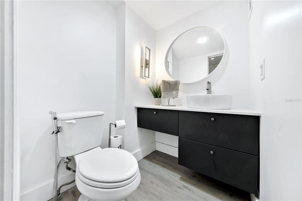 11 Island Avenue, Unit 309 Miami Beach, FL 33139 - Photo 21 of 28 a bathroom with a toilet a sink and mirror